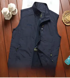 Detail of navy outdoor vest showing breathable mesh lining and embroidered chest logo