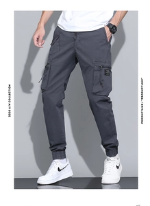 Detailed view of dark grey cargo pants featuring functional large pockets and ribbed cuffs