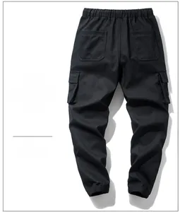 Detail of black cargo pants featuring elastic waistband and functional flap pockets back view