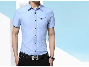 Detail of light blue short sleeve shirt with flap pocket and black buttons for men