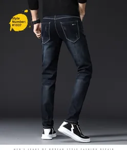 Detailed back view of slim fit dark blue jeans with micro-distressed pocket and classic tag