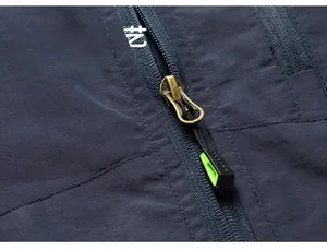 Detailed macro view of high-quality metal zipper on a durable blue outdoor utility vest