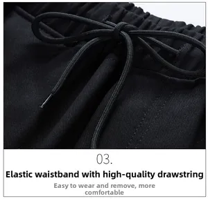 Detail view of elastic waistband with black woven drawstring on cargo pants