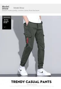 Detail of army green cargo jogger pants with side flap pockets and red zipper accent
