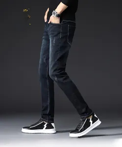 Slim fit men's dark blue stretch jeans with cat-whisker fading and contrast stitching