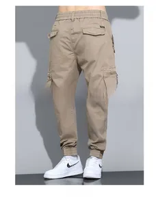 Detail of khaki cargo pants featuring elastic waist, multi-pockets and ribbed cuffs