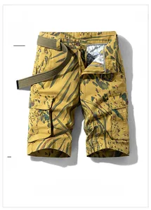 Detail view of yellow leaf camouflage cargo shorts with canvas belt and side utility pockets