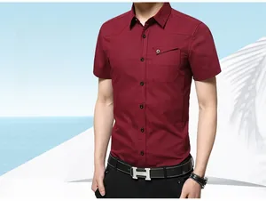 Detail of slim fit wine red short sleeve shirt featuring chest pocket and metal button