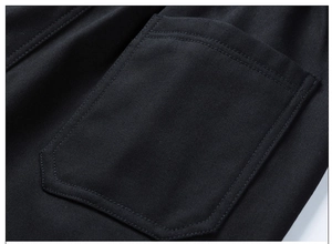 Detail of cargo pants pocket showing high-quality twill fabric and neat stitching in black