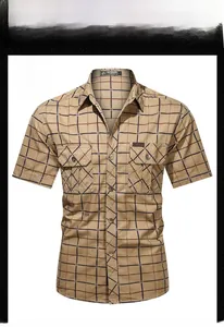Detail of khaki plaid short-sleeve shirt featuring dual chest pockets and button closure