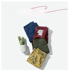 Flat lay of multi-colored cotton cargo shorts including navy, green and floral patterns