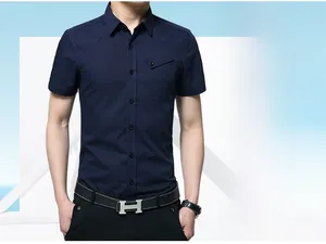 Detail of slim-fit men's navy blue short-sleeve shirt featuring a buttoned chest pocket