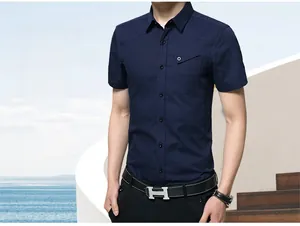 Detail of slim fit navy short sleeve shirt with chest pocket and tonal buttons