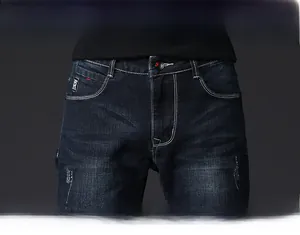 Detail view of denim waist with contrast stitching and metallic button closure