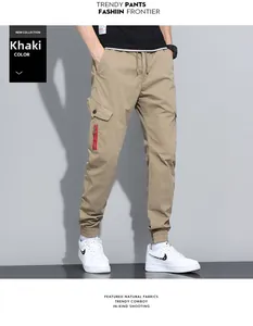 Detail view of khaki cargo pants featuring large side pockets and a red zipper accent