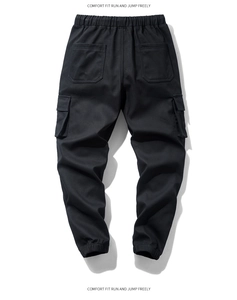 Detail of men's black cargo joggers showing elastic waist and side flap pockets