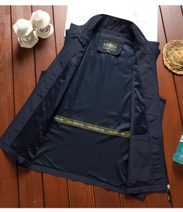 Detail view of deep blue outdoor vest with breathable mesh lining and stand collar