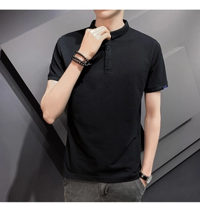 Detail of black slim-fit polo shirt sleeve with blue woven label and premium cotton texture