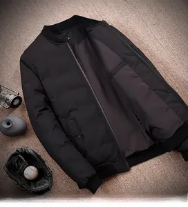 Detail of black bomber jacket showing 90% white duck down filling and inner lining