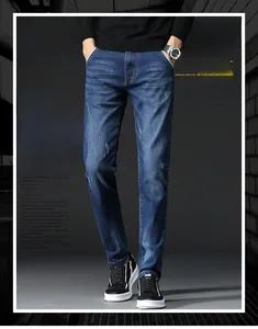 Detail of dark blue slim fit denim jeans showing whisker patterns and fabric texture