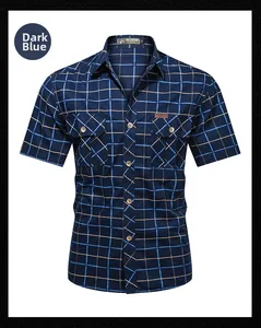 Detailed view of the dark blue plaid shirt showing chest pockets and outdoor labels