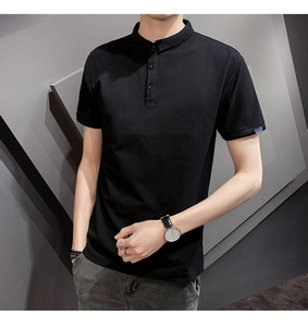 Close-up of black polo shirt sleeve featuring a small purple woven label and fine stitching