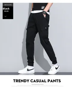 Detail view of black cargo jogger pants with side flap pockets and adjustable drawstring waist