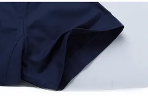 Macro shot of precise stitching on the cuff of a navy blue cotton short sleeve shirt