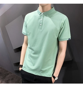 Close-up of mint green polo shirt featuring a classic collar and navy blue sleeve tag