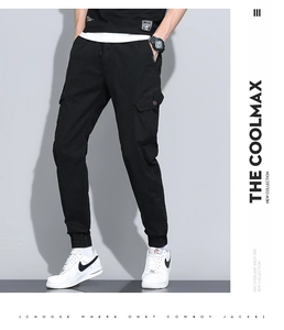Detail view of black cargo joggers showing side flap pockets and elastic ankle cuffs