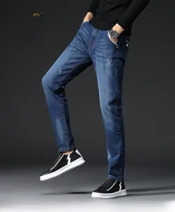 Detail view of slim fit denim jeans showing distressed fabric texture and repair craft