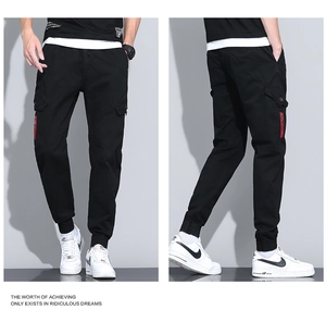 Detail of men's black cargo joggers with side pockets, drawstring waist and ribbed cuffs
