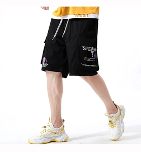 Detail of black cargo shorts with large pockets, white drawstring, and graphic print