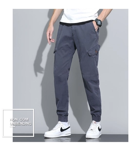 Close-up of grey cargo pants featuring a large side pocket and elastic ribbed cuffs