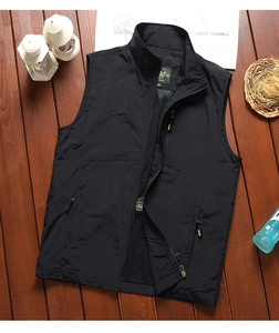 Detail view of black outdoor vest with breathable mesh lining and a secure zipper