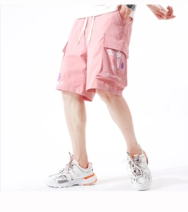 Pink cargo shorts for men with white drawstrings and streetwear letter print details