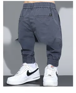 Detail of men's jogger pants showing elastic waist, back pocket and ribbed cuffs