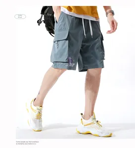 Detail of cargo shorts in grey-blue with large flap pockets and SUP letter printing