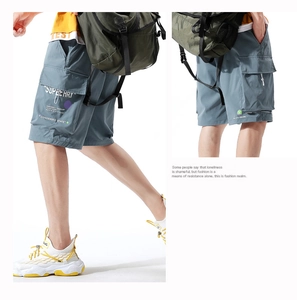Detail view of cargo shorts showing side accordion pockets and street style printing