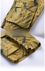 Detail view of tropical camo cargo shorts featuring side flap pocket and reinforced hem