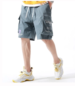 Detail of greyish-blue cargo shorts featuring multiple pockets and white graphic prints