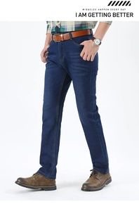 Detail view of dark blue straight-leg jeans with classic wash and yellow stitching