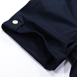 Short sleeve navy military style shirt featuring buttoned cuff details and durable fabric