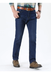 Detail of dark blue straight-leg denim jeans with leather belt and classic fit design