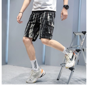 Detail of cargo shorts side pocket with black and white abstract ink print pattern