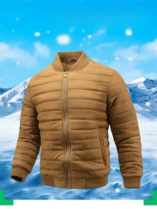 Detail of a brown quilted bomber jacket with ribbed cuffs and winter mountain background