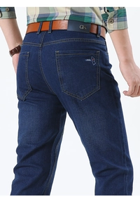 Detail view of men's dark blue jeans featuring contrast stitching and back pocket embroidery
