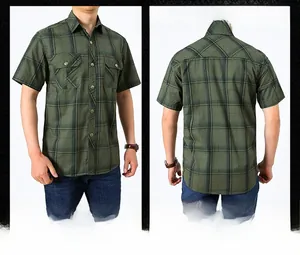 Close-up detail of men's dark green plaid cotton work shirt with double chest pockets