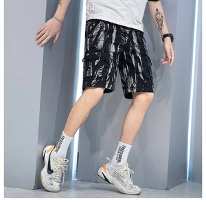Detail view of cargo shorts featuring large side gusset pockets and grey camouflage print