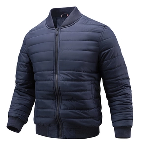 Detail of navy blue quilted bomber jacket with ribbed collar and windproof metal zipper